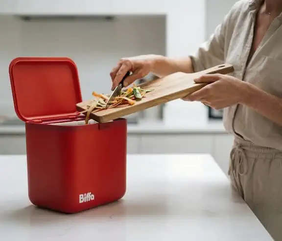 Food getting scrapped into red food caddy