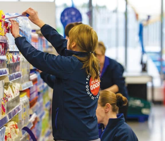 Company Shop worker stacking shelves
