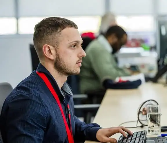 Biffa employee at desk looking at monitor