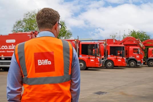 Biffa employee in high vis by vehicles