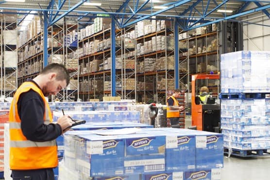 Worker in front of pallet boxes