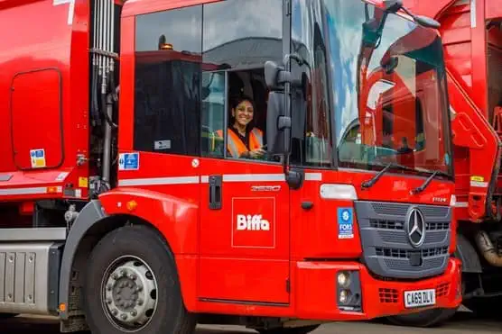 Female employee smiling in a Biffa truck