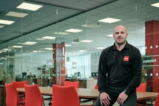 Male employee sitting on office desk