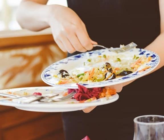 Waiter clearing plates