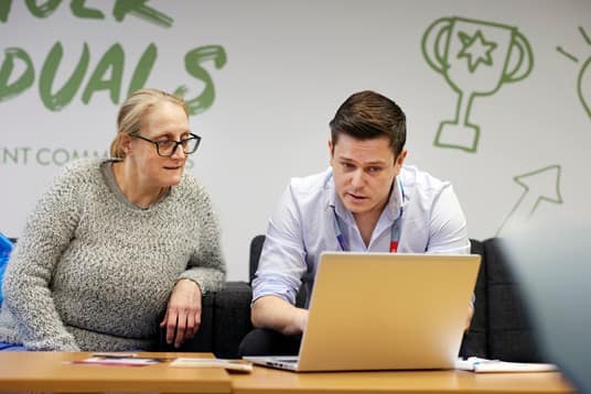 Members of ISS working together to help social enterprise Community Shop apply for employment roles with ISS