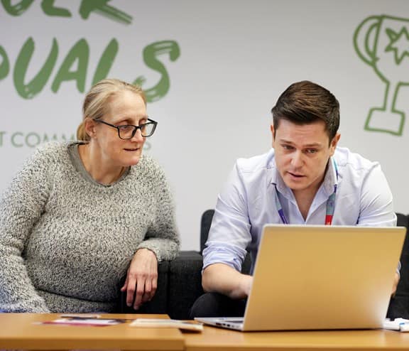 Members of ISS working together to help social enterprise Community Shop apply for employment roles with ISS