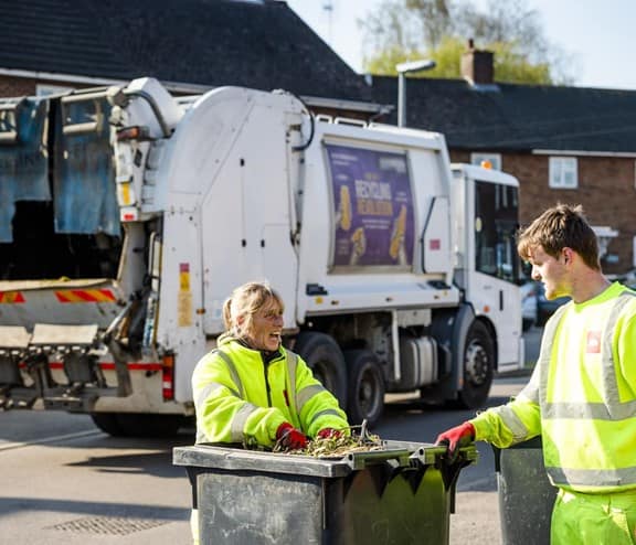 Two biffa binmen collecting bins