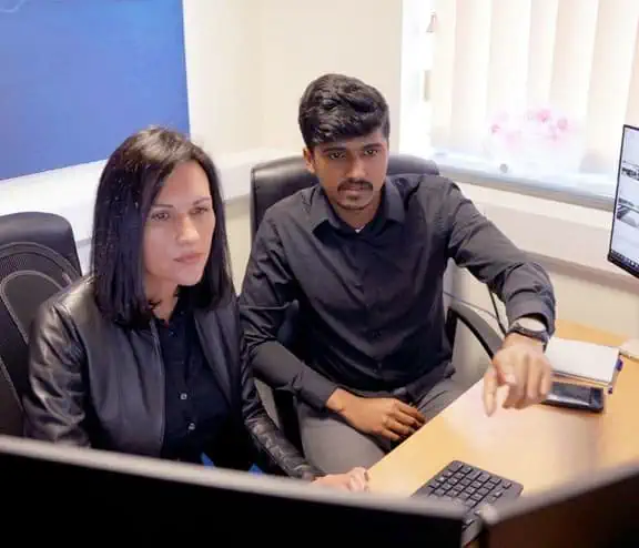 Employees discussing data from a screen