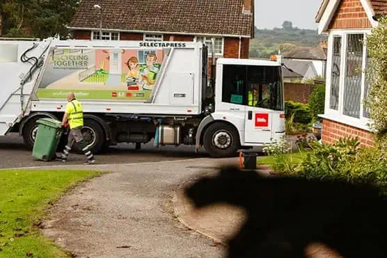 Biffa municipal collection behind leaves